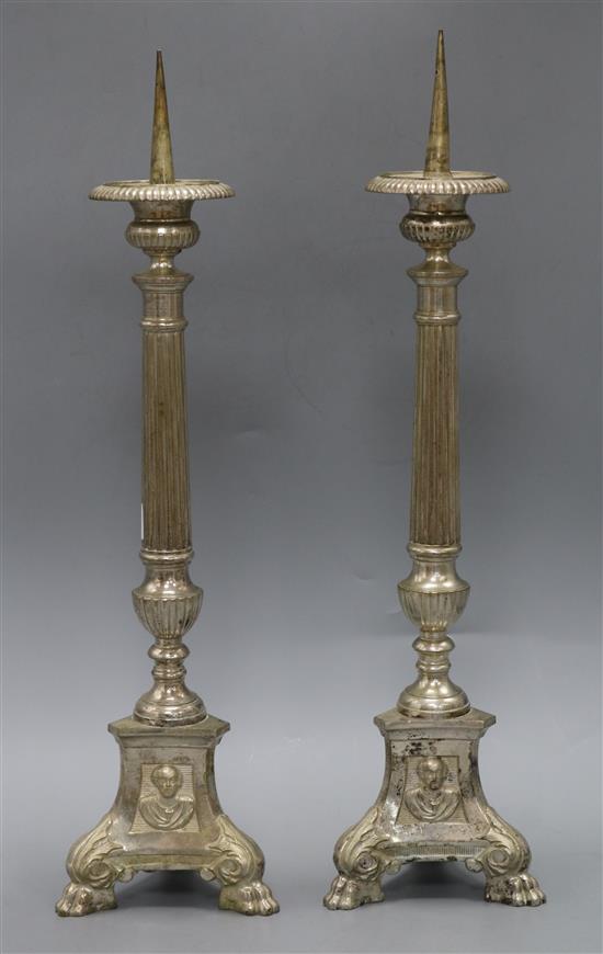 A pair of silver plated on brass pricket candlesticks height 52cm